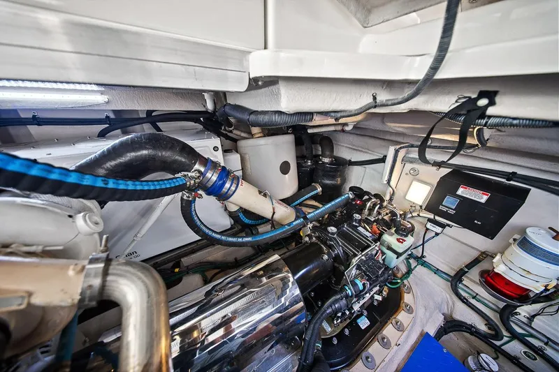 Slide: The Image of Engine room of a 2012 Sea Ray 470 Sundancer, showcasing mechanical components and wiring. - 11