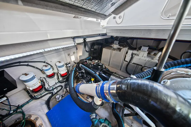 Slide: The Image of Engine room of 2012 Sea Ray 470 Sundancer, showcasing mechanical components and systems. - 12