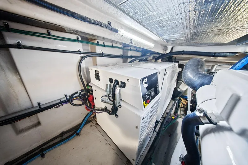 Slide: The Image of Engine room of 2012 Sea Ray 470 Sundancer, showcasing electrical components and wiring. - 13