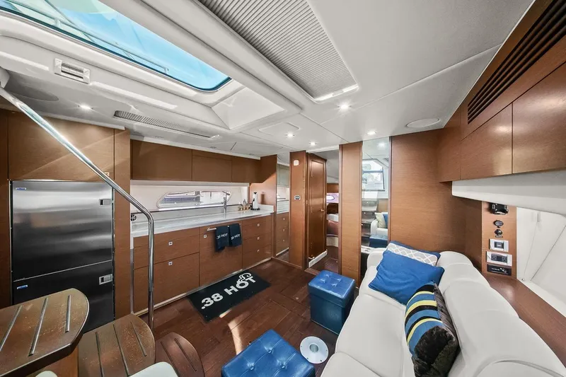 Slide: The Image of Luxurious interior of 2012 Sea Ray 470 Sundancer yacht with modern furnishings and skylight. - 14