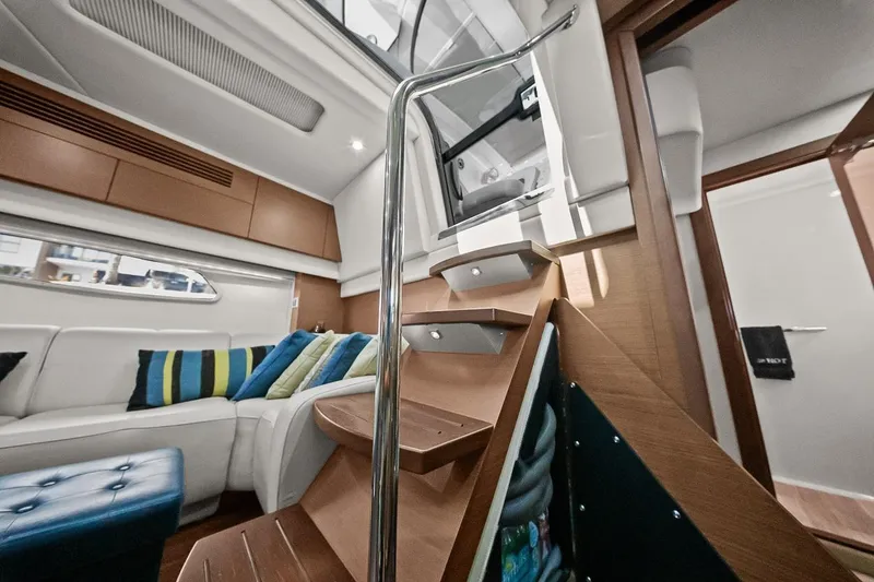 Slide: The Image of Luxurious interior of 2012 Sea Ray 470 Sundancer yacht with modern seating and staircase. - 16