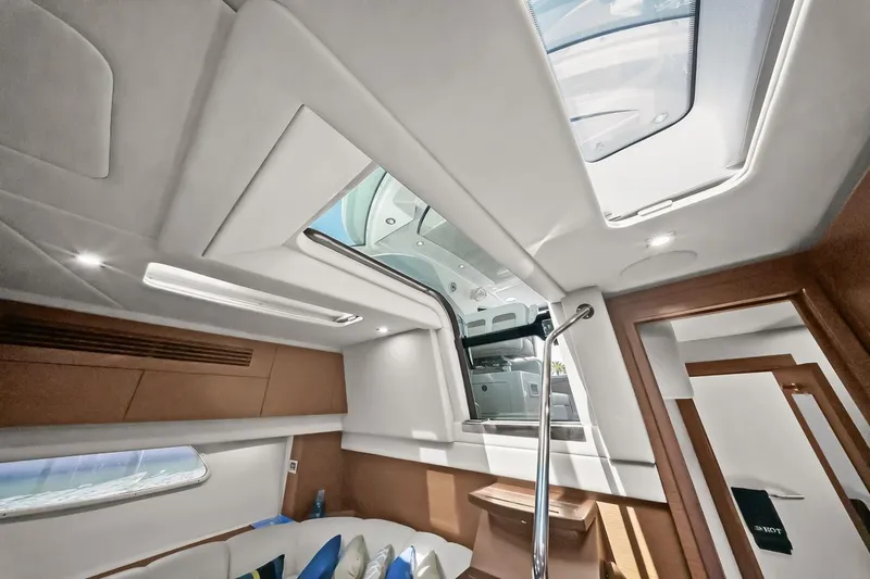 Slide: The Image of Interior view of 2012 Sea Ray 470 Sundancer yacht, featuring modern design and skylights. - 21