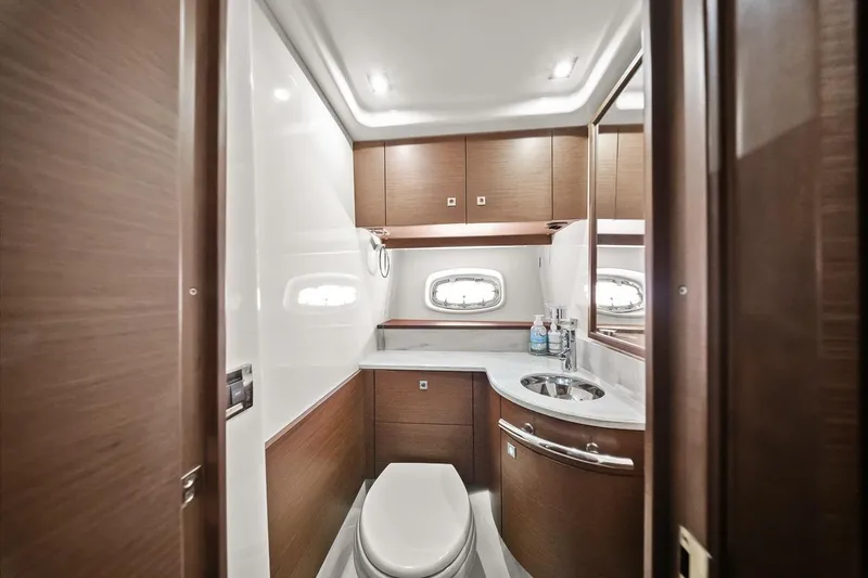 Slide: The Image of Luxurious bathroom in 2012 Sea Ray 470 Sundancer yacht with modern fixtures and wood accents. - 25