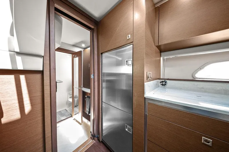 Slide: The Image of Interior of 2012 Sea Ray 470 Sundancer yacht, featuring modern kitchen and bathroom. - 29