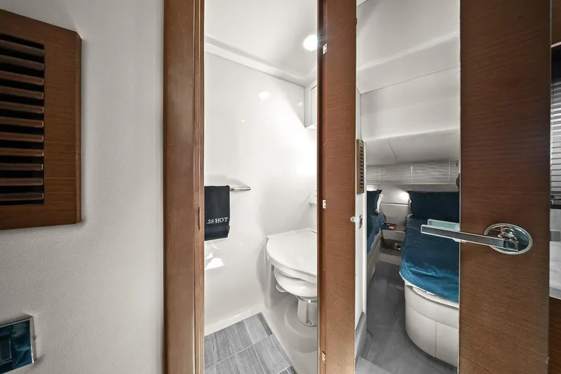 Slide: The Image of Interior of 2012 Sea Ray 470 Sundancer yacht, featuring a modern bathroom and cozy bedroom. - 30