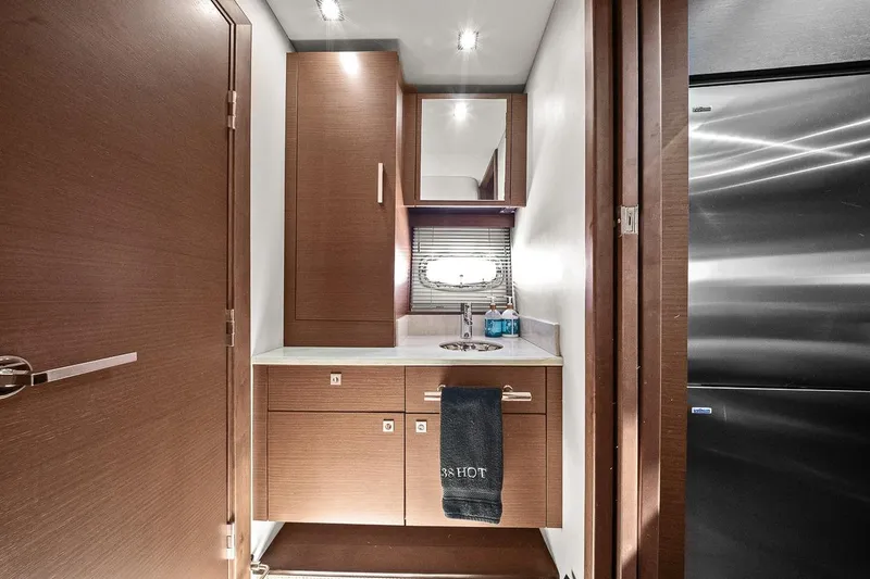 Slide: The Image of Interior of 2012 Sea Ray 470 Sundancer yacht, featuring a modern bathroom with wood cabinetry. - 32