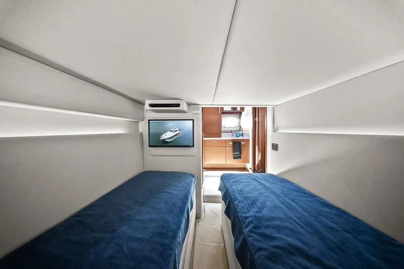 Slide: The Image of Cabin interior of 2012 Sea Ray 470 Sundancer with twin beds and TV. - 33