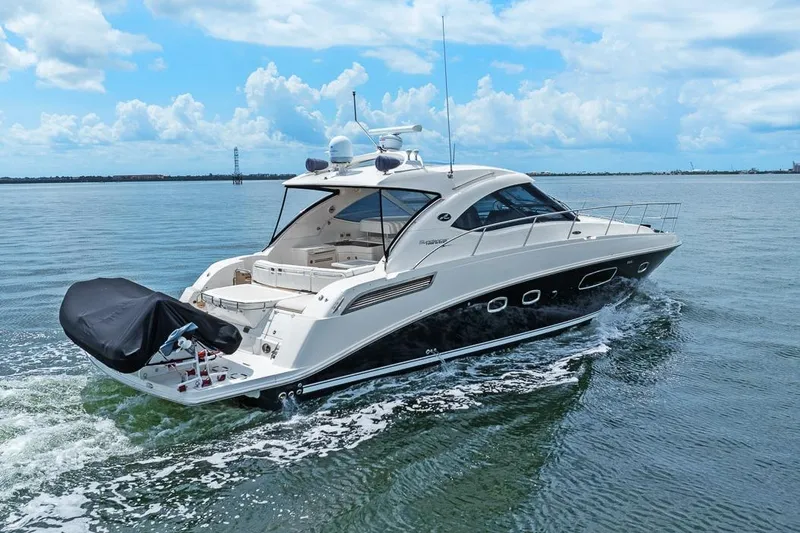 Slide: The Image of 2012 Sea Ray 470 Sundancer cruising on calm waters under a blue sky. - 34