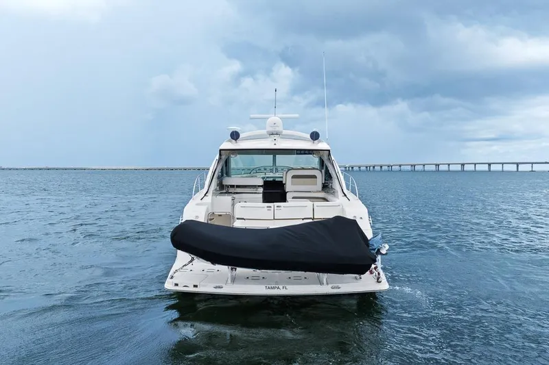 Slide: The Image of 2012 Sea Ray 470 Sundancer yacht on open water with bridge in background. - 41