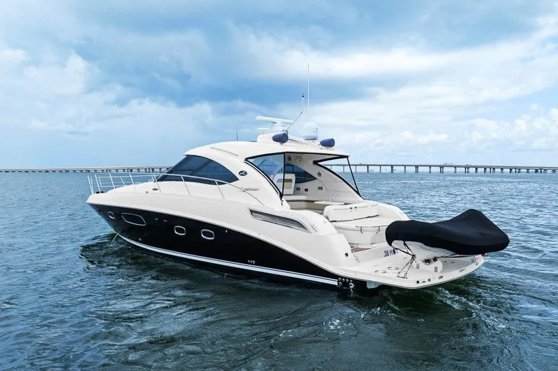 Slide: The Image of 2012 Sea Ray 470 Sundancer yacht cruising on open water under a cloudy sky. - 42