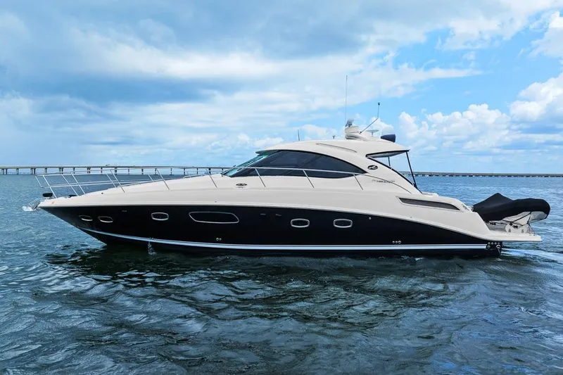 Slide: The Image of 2012 Sea Ray 470 Sundancer yacht on open water under a cloudy sky. - 43