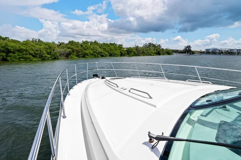 Slide: The Image of Sea Ray 470 Sundancer 2012 cruising on a scenic waterway with lush greenery. - 49