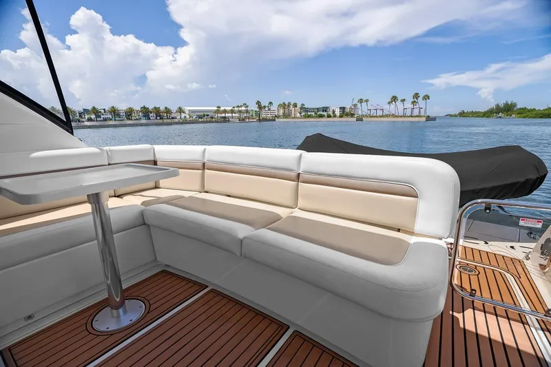 Slide: The Image of Luxurious 2012 Sea Ray 470 Sundancer yacht with elegant seating and scenic water view. - 56