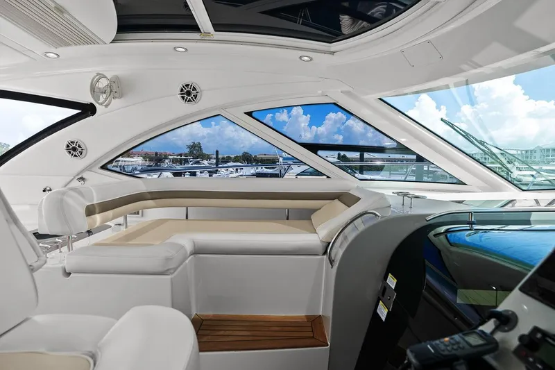 Slide: The Image of Luxurious interior of 2012 Sea Ray 470 Sundancer yacht with panoramic windows and plush seating. - 60