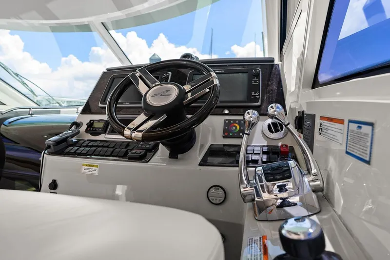 Slide: The Image of Control panel of 2012 Sea Ray 470 Sundancer yacht with steering wheel and throttle levers. - 61