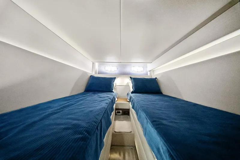 Slide: The Image of Interior cabin of 2012 Sea Ray 470 Sundancer with twin blue beds. - 7
