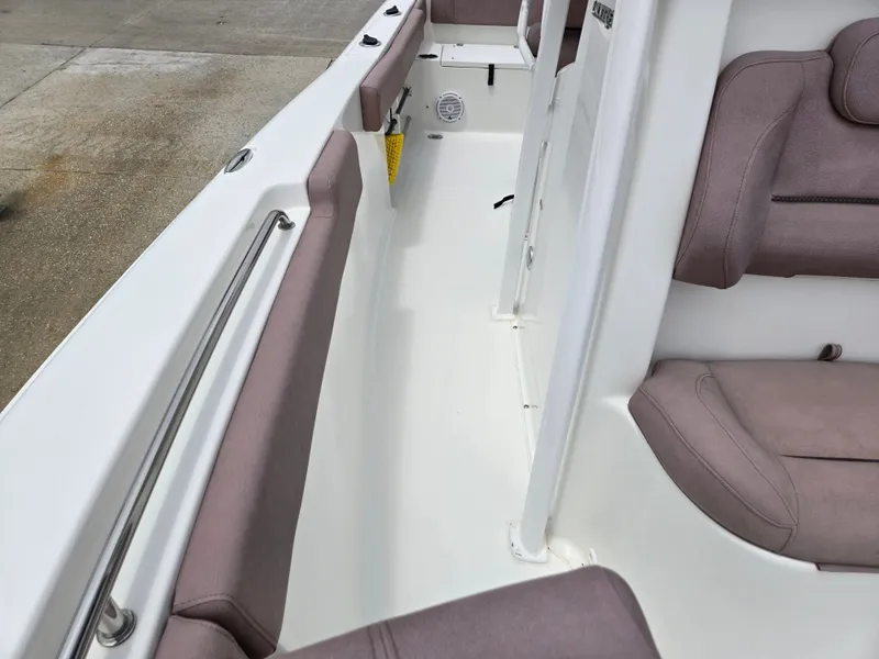 Slide: The Image of 2019 Sea Hunt 225 Ultra boat interior with cushioned seating and sleek design. - 10