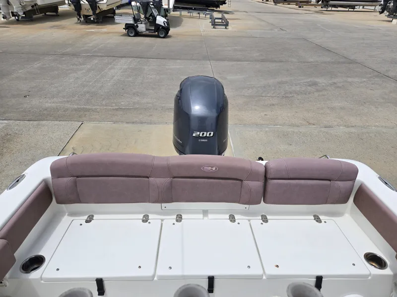 Slide: The Image of 2019 Sea Hunt 225 Ultra boat with Yamaha 200 engine, docked on concrete. - 3