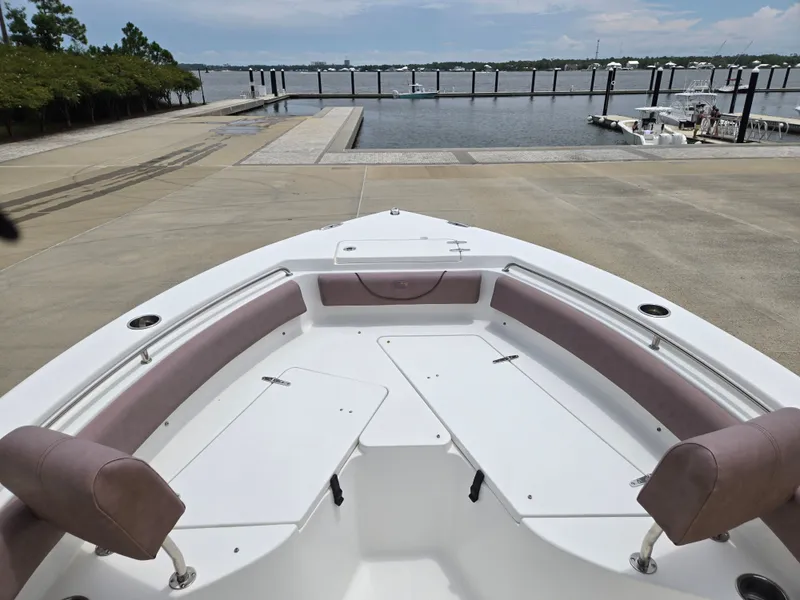 Slide: The Image of 2019 Sea Hunt 225 Ultra boat at dock, featuring spacious seating and sleek design. - 4