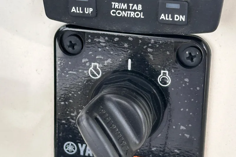Slide: The Image of Close-up of 2024 Pioneer 222 Islander trim tab control and ignition switch. - 10