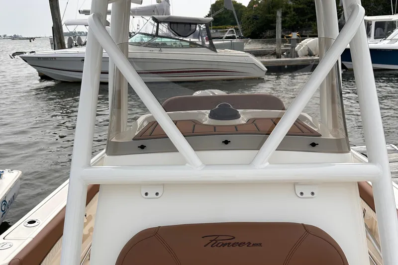 Slide: The Image of 2024 Pioneer 222 Islander boat docked, showcasing sleek design and modern features. - 11