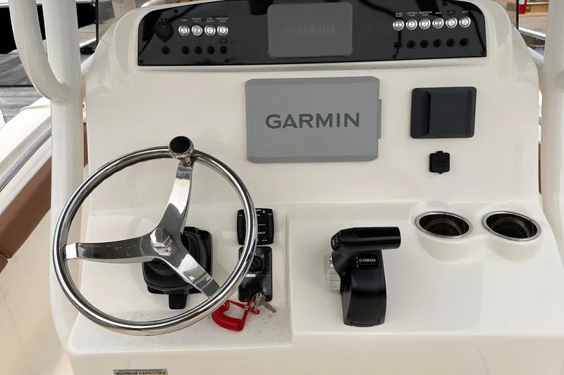 Slide: The Image of 2024 Pioneer 222 Islander boat dashboard with Garmin navigation and Yamaha controls. - 12