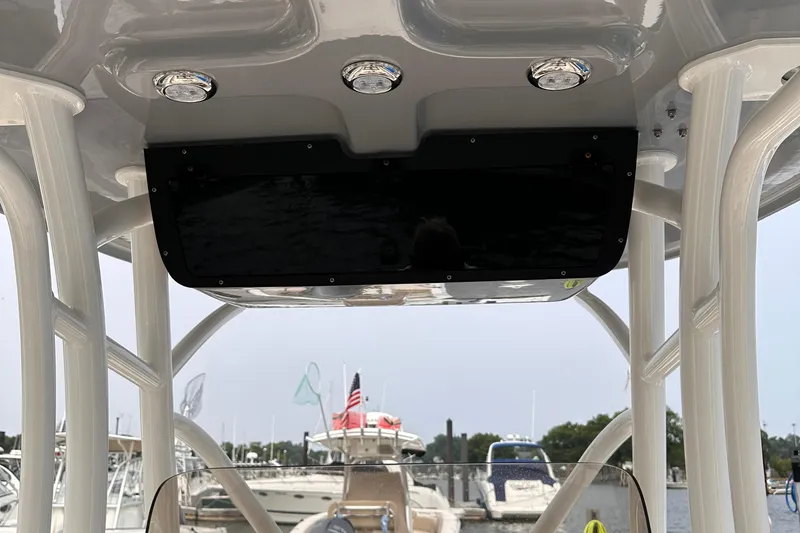 Slide: The Image of 2024 Pioneer 222 Islander boat console with overhead lights at marina. - 13
