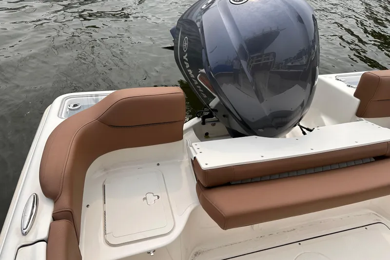 Slide: The Image of 2024 Pioneer 222 Islander boat with Yamaha engine, featuring brown seating and white deck. - 15