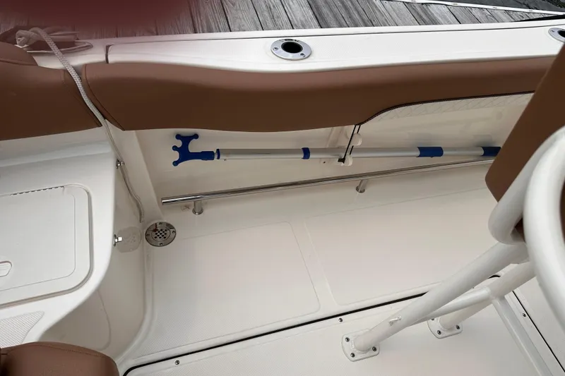 Slide: The Image of 2024 Pioneer 222 Islander boat interior with storage compartment and deck details. - 5