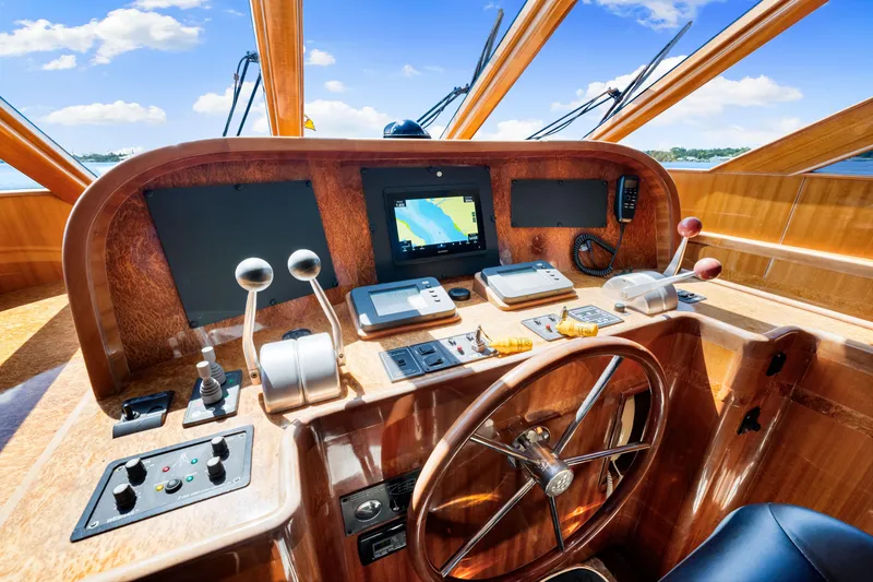 Slide: The Image of Pilothouse of 2007 Hampton 558 yacht with navigation equipment and wooden steering wheel. - 18