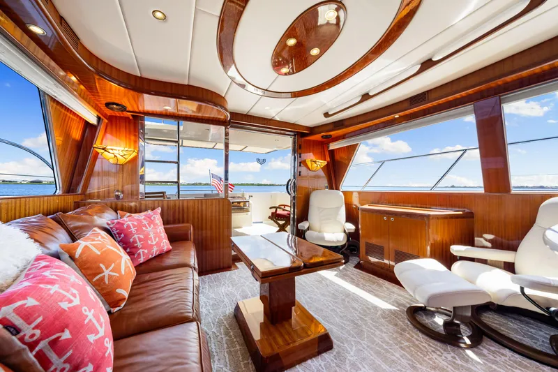 Slide: The Image of Luxurious interior of 2007 Hampton 558 Pilothouse yacht with elegant wood finishes and plush seating. - 22