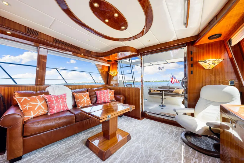 Slide: The Image of Luxurious interior of 2007 Hampton 558 Pilothouse yacht with leather seating and elegant wood finishes. - 23