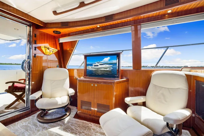 Slide: The Image of Luxurious interior of 2007 Hampton 558 Pilothouse yacht with plush seating and scenic views. - 25