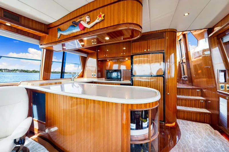 Slide: The Image of Luxurious 2007 Hampton 558 Pilothouse yacht interior with elegant wood finishes and modern amenities. - 26