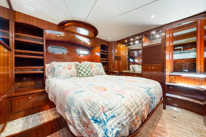 Slide: The Image of Luxurious bedroom interior of 2007 Hampton 558 Pilothouse yacht with elegant wood finishes. - 32