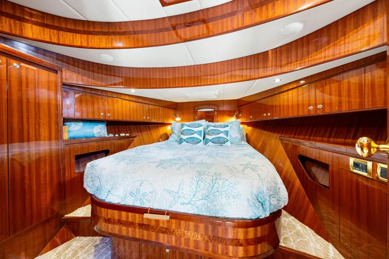 Slide: The Image of Luxurious 2007 Hampton 558 Pilothouse yacht bedroom with elegant wood finish and cozy bedding. - 37