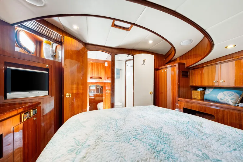 Slide: The Image of Luxurious 2007 Hampton 558 Pilothouse yacht bedroom with wood paneling and modern amenities. - 38