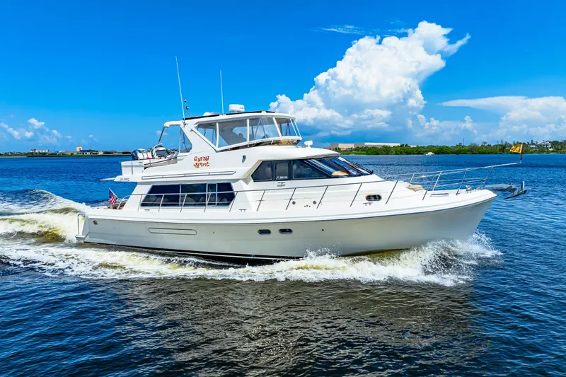 Slide: The Image of 2007 Hampton 558 Pilothouse yacht cruising on a sunny day with blue skies. - 41