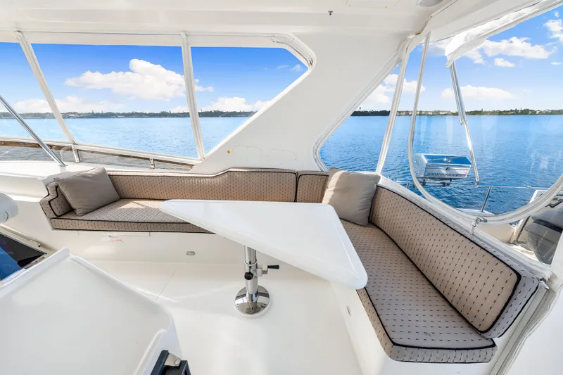 Slide: The Image of Luxurious 2007 Hampton 558 Pilothouse yacht interior with ocean view and seating area. - 47