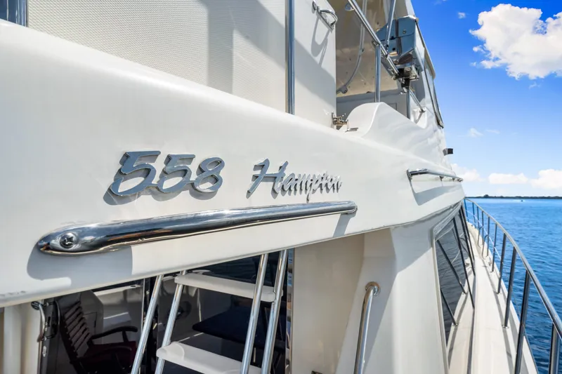 Slide: The Image of 2007 Hampton 558 Pilothouse yacht on calm blue water, showcasing sleek design. - 57
