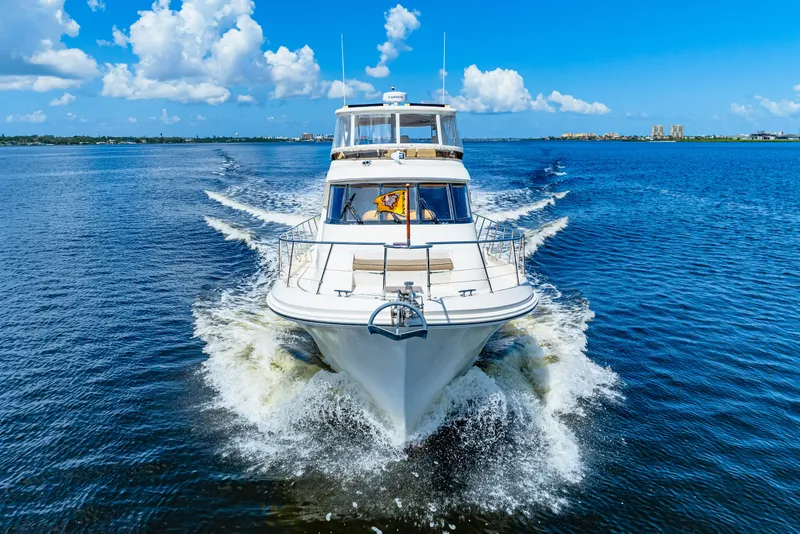 Slide: The Image of 2007 Hampton 558 Pilothouse yacht cruising on a sunny day with blue skies. - 65