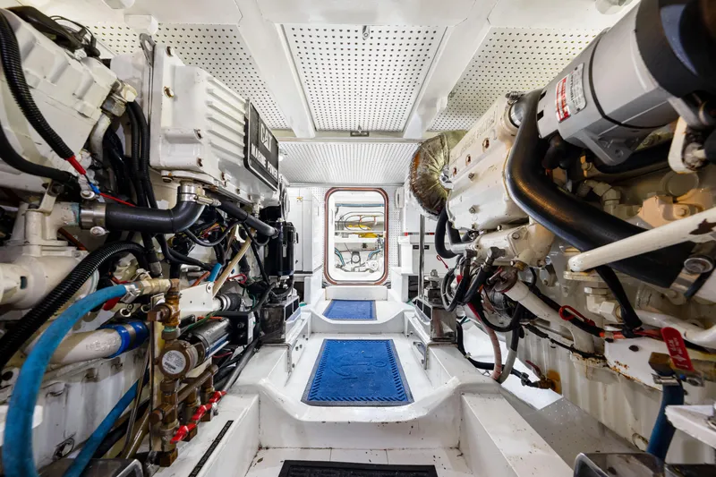 Slide: The Image of Engine room of 2007 Hampton 558 Pilothouse yacht, featuring dual engines and mechanical systems. - 69