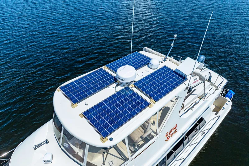 Slide: The Image of 2007 Hampton 558 Pilothouse yacht with solar panels on calm water. - 74