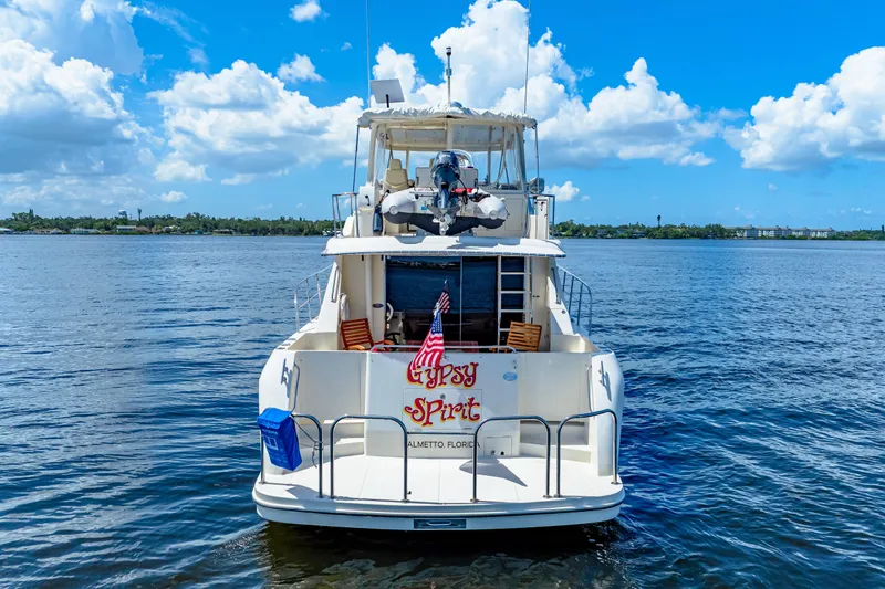 Slide: The Image of 2007 Hampton 558 Pilothouse yacht on calm water under a bright blue sky. - 75