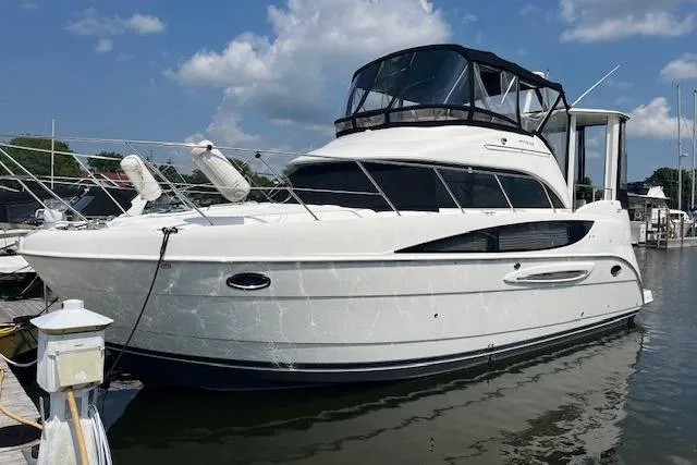 Slide: The Image of 2005 Meridian 368 Motoryacht docked in a marina under a clear blue sky. - 0
