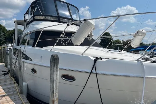 Slide: The Image of 2005 Meridian 368 Motoryacht docked, featuring sleek design and spacious deck. - 1