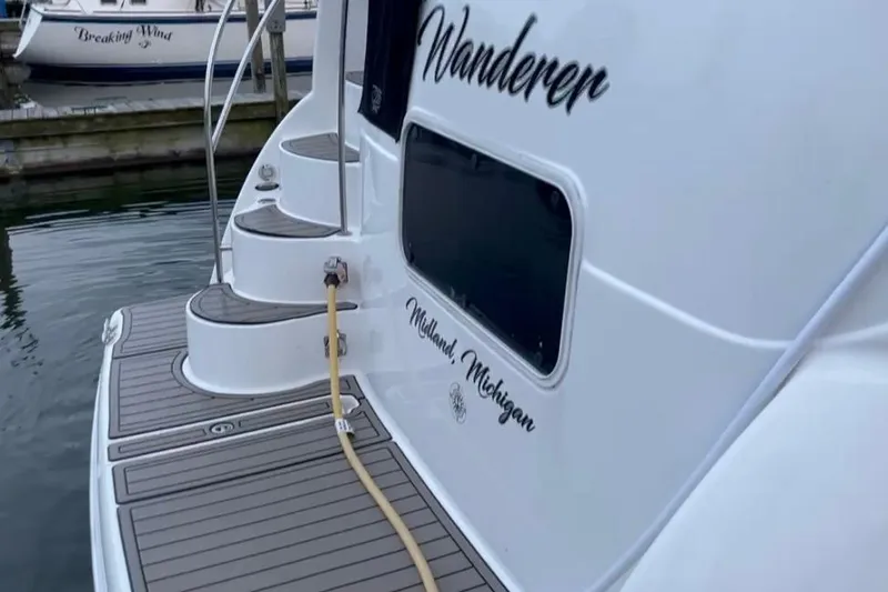 Slide: The Image of 2005 Meridian 368 Motoryacht docked, featuring "Wanderer" name and Midland, Michigan location. - 10