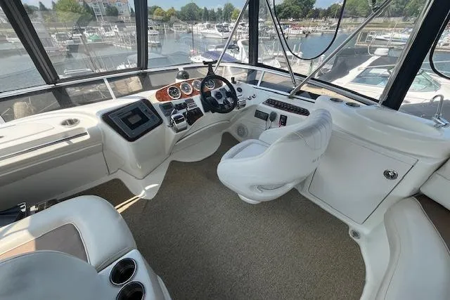Slide: The Image of 2005 Meridian 368 Motoryacht helm with modern controls and panoramic marina view. - 11