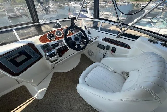 Slide: The Image of 2005 Meridian 368 Motoryacht helm with white leather seat and modern controls. - 12