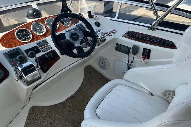 Slide: The Image of 2005 Meridian 368 Motoryacht helm with steering wheel, gauges, and control panel. - 13